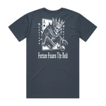 A dusty blue t-shirt with a graphic design of a skeleton wearing a crown and playing cards, with text on the back.